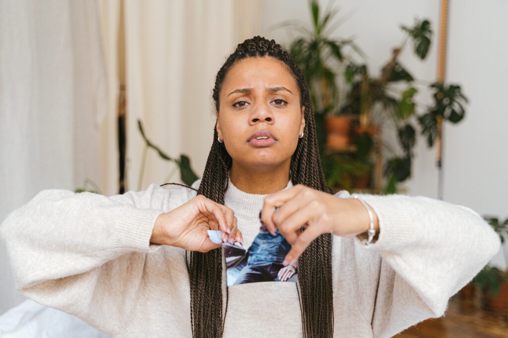 A Woman Holding a Torn Photo